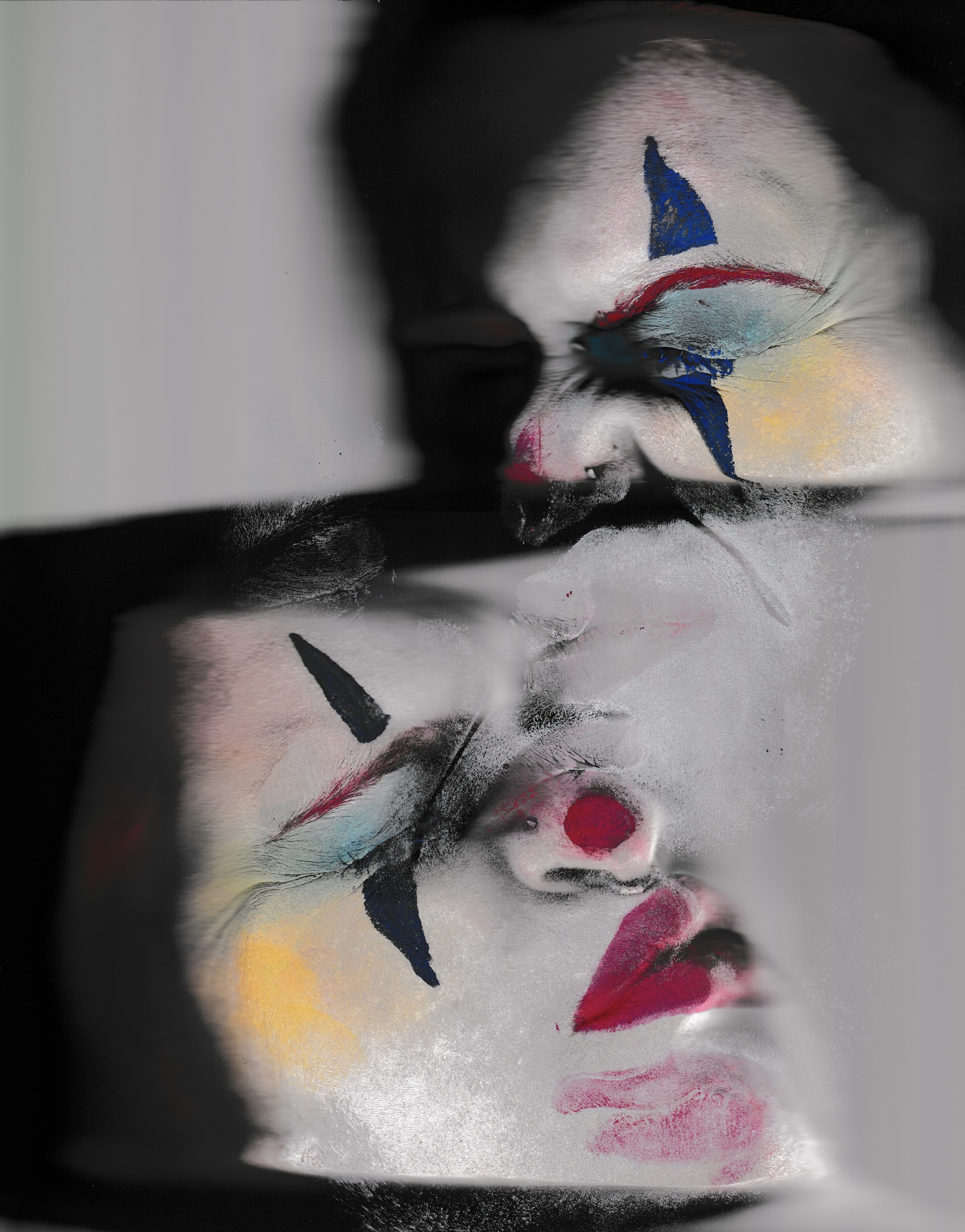 a scanned image of a person in clown makeup's face, distorted and pressed against a scanner