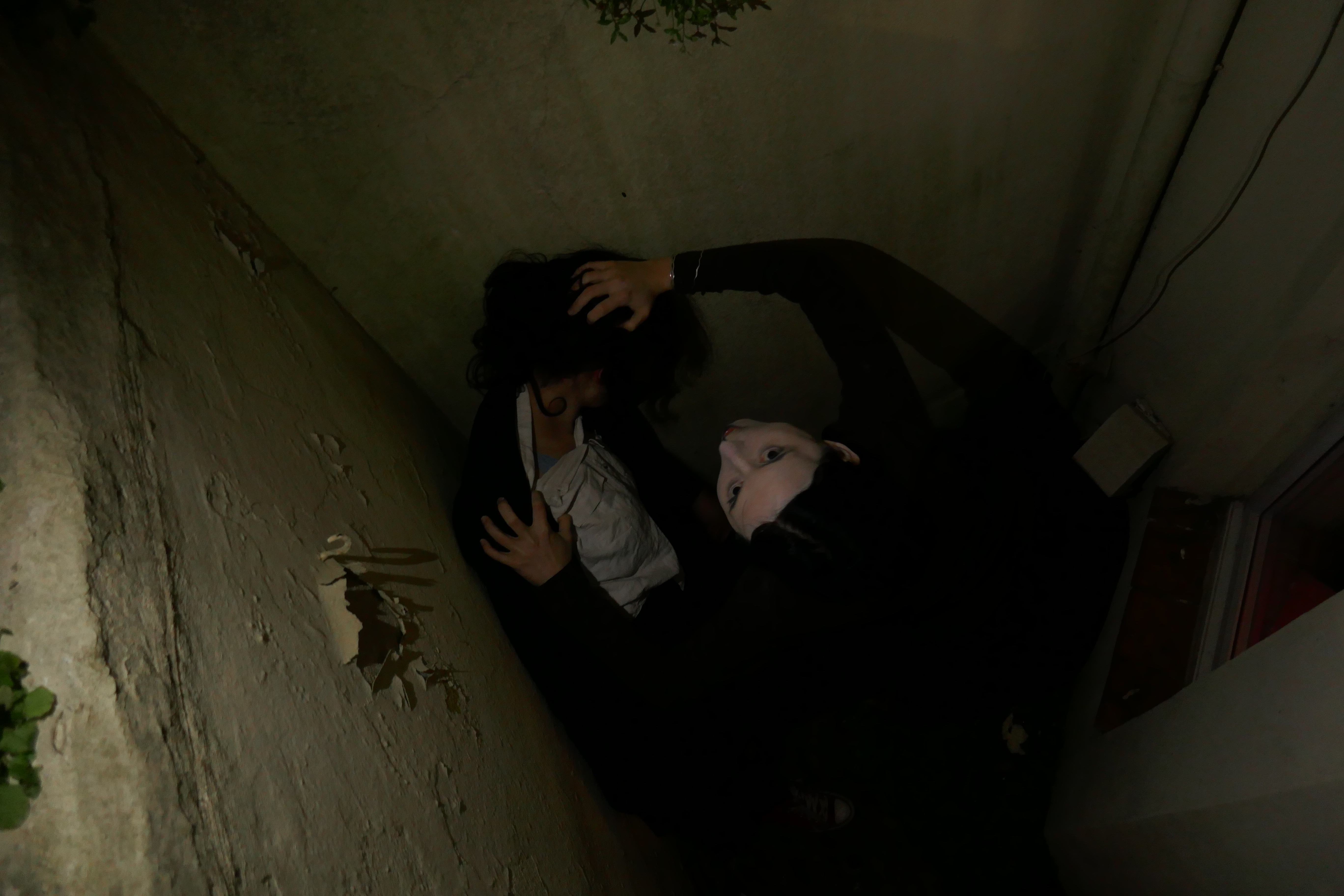 a photograph of an uncanny looking figure attacking a young woman