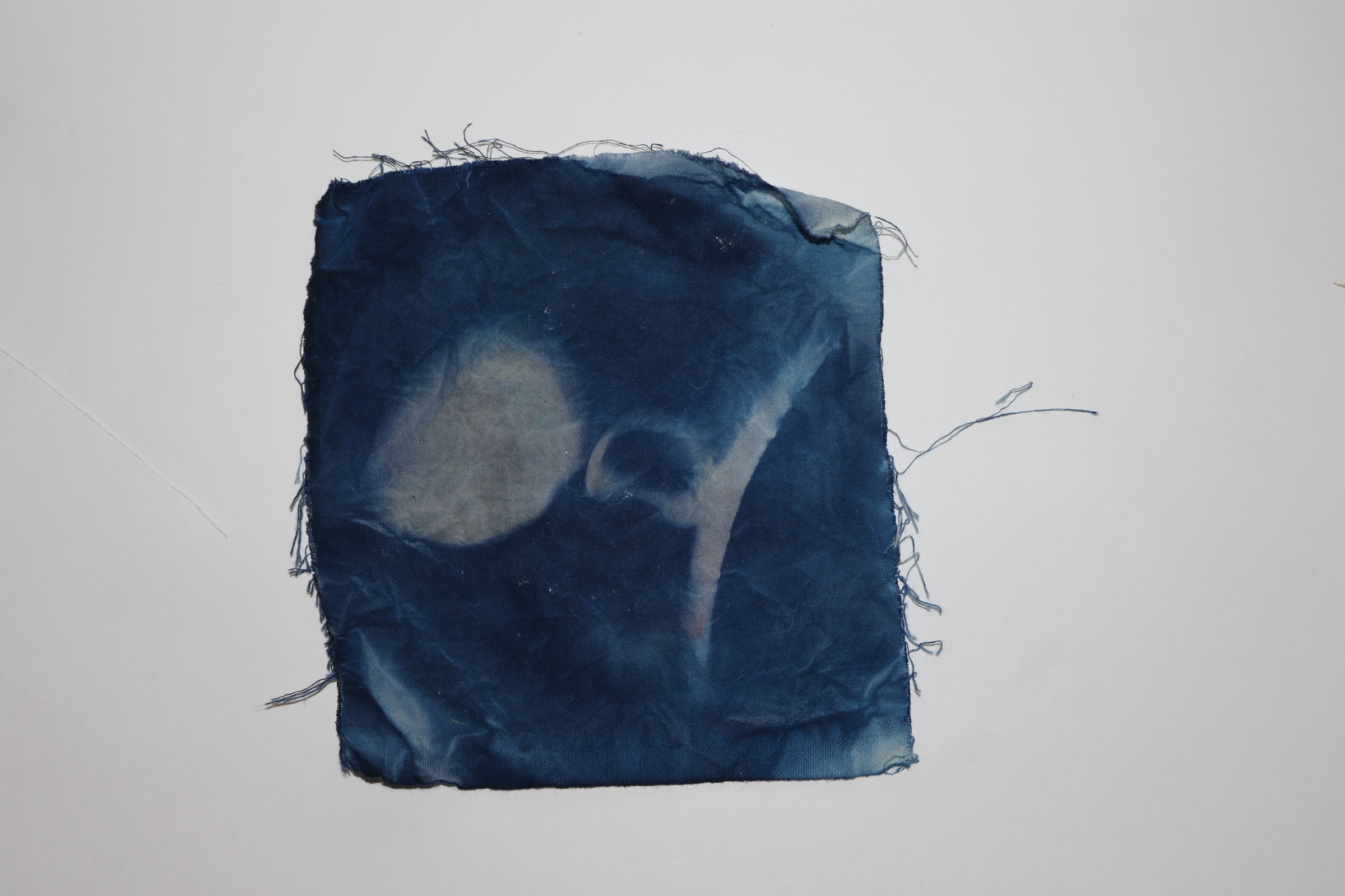 a cyanotype on frayed fabric