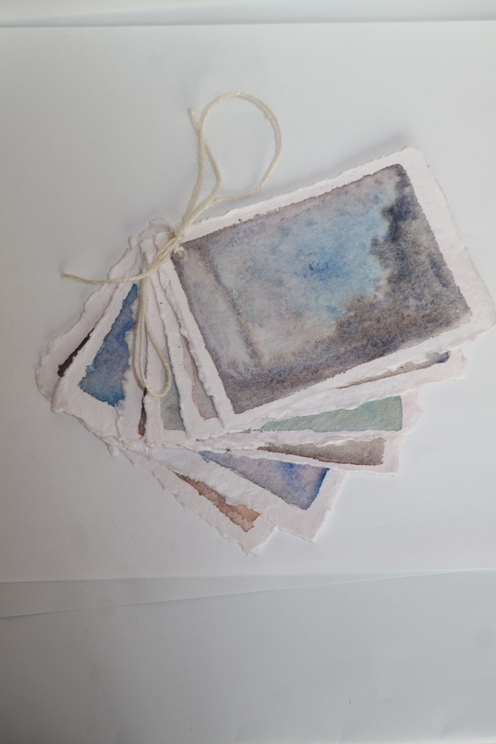 hand bound water colour prints held together by twine